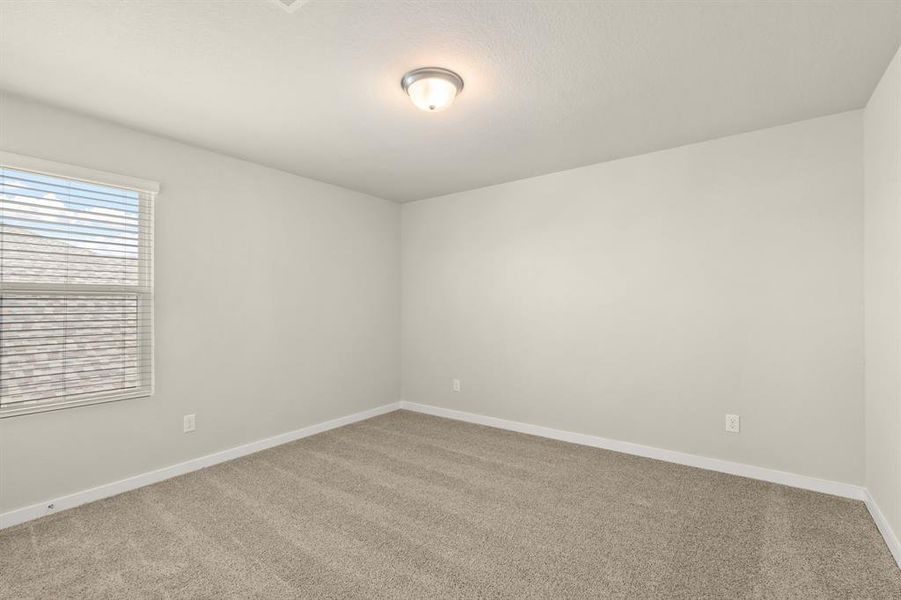 Stunning Secondary bedroom on second floor featuring plush carpet, neutral finishes and easy access to the Flex Space and bathroom.