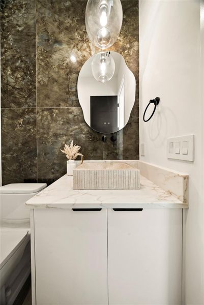 Half bath with vanity and tile walls Half bath with vanity and tile walls