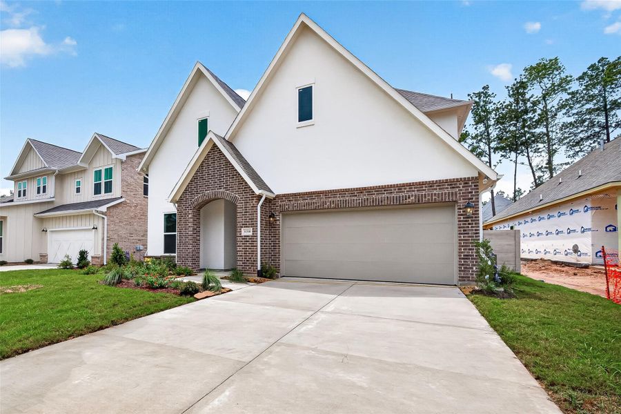 Front exterior of a new home in Two Step Farm, Montgomery, TX, highlighting curb appeal (Image 2). Front exterior of a new home in Two Step Farm, Montgomery, TX, highlighting curb appeal (Image 2).