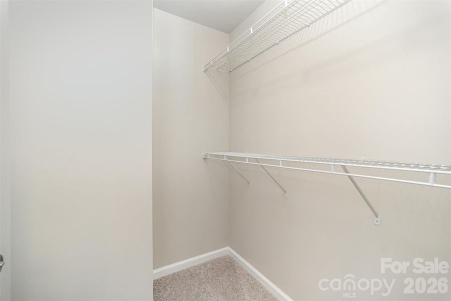 Primary suite walk-in closet Primary suite walk-in closet