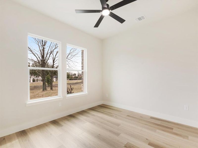 Spare room featuring light wood-type flooring and ceiling fan