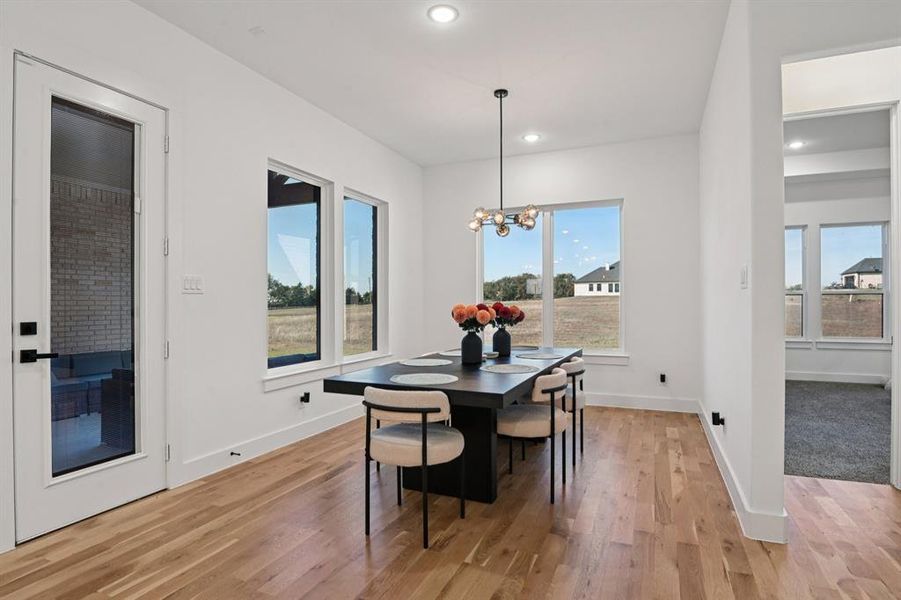 Dining room off entry with light wood-type flooring, a chandelier, and recessed lighting Dining room off entry with light wood-type flooring, a chandelier, and recessed lighting