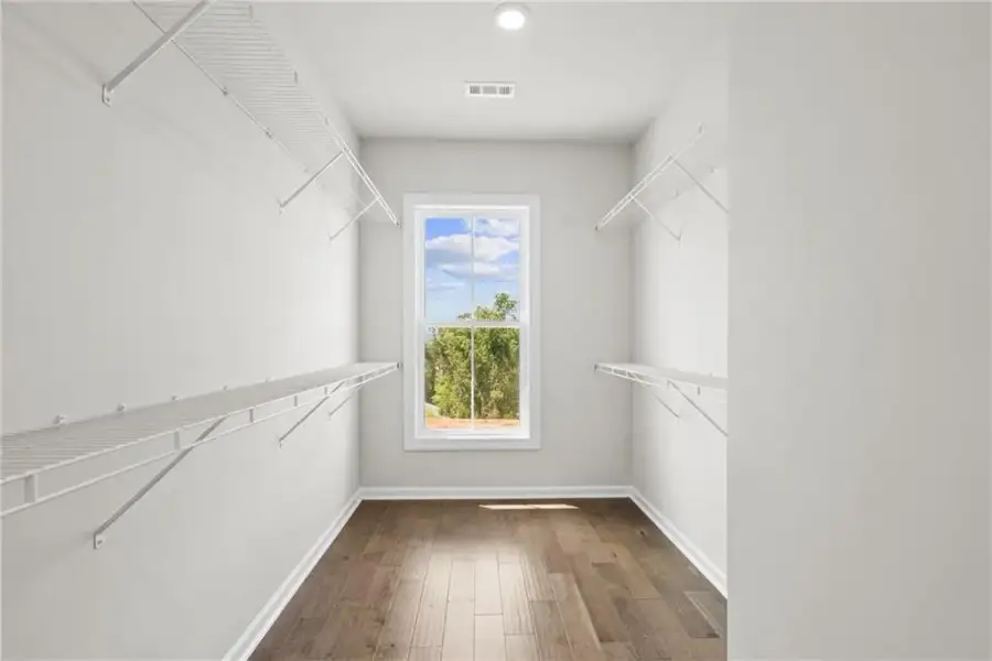 Primary closet with tons of natural light *Images shown are from a different homesite featuring the Aspen Floor Plan. Design selections and colors will vary by home. *