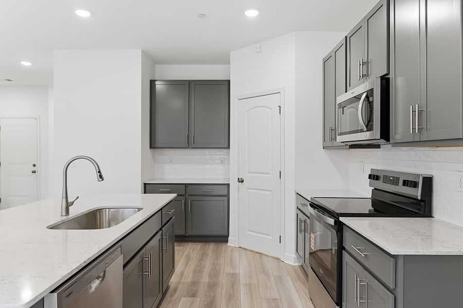A kitchen with black cabinets.