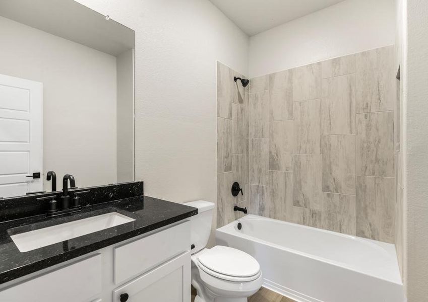 Secondary bathroom with a dual shower and bath tub.