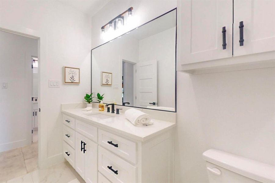 Bathroom featuring vanity and toilet Bathroom featuring vanity and toilet