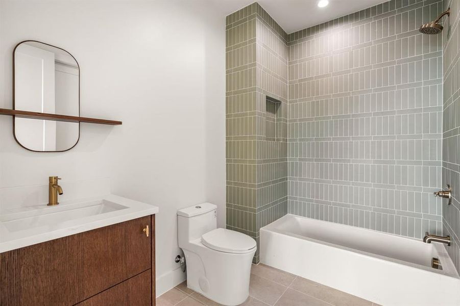 Full bathroom with light tile patterned flooring, vanity, and shower / washtub combination Full bathroom with light tile patterned flooring, vanity, and shower / washtub combination