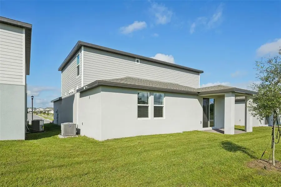 Exterior details and patio area of a home in The Meadow at Crossprairie, St. Cloud (Image 3).