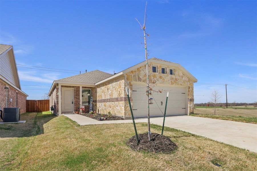 Front exterior of a new home in Mobberly Farms, Pilot Point, TX, highlighting curb appeal (Image 21).