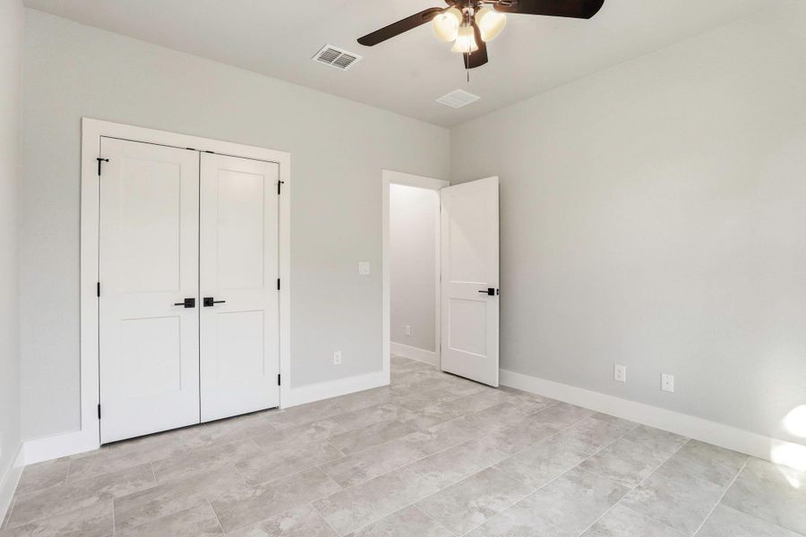 Bright and airy, this bedroom features resilient tile flooring and clean lines, offering a perfect blank canvas. Bright and airy, this bedroom features resilient tile flooring and clean lines, offering a perfect blank canvas.