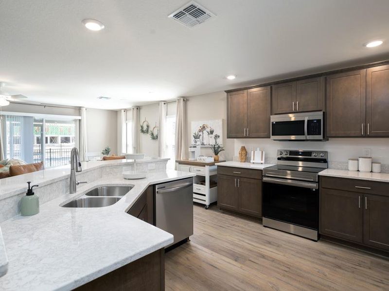 Your spacious kitchen includes ample cabinet and counter space, a pantry, and a butterfly island - Magnolia townhome by Highland Homes