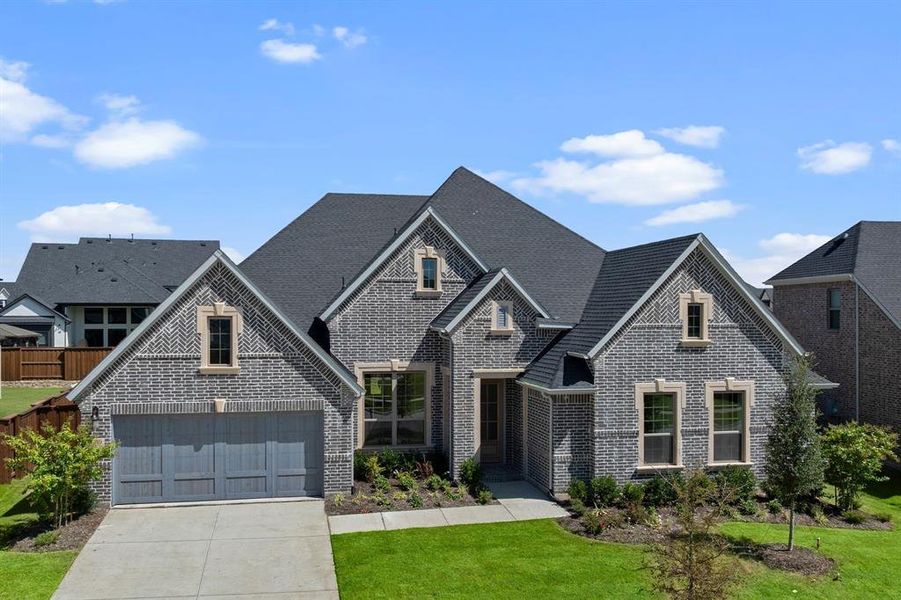 Front exterior of a new home in Windsong Ranch, Prosper, TX, highlighting curb appeal (Image 1). Front exterior of a new home in Windsong Ranch, Prosper, TX, highlighting curb appeal (Image 1).