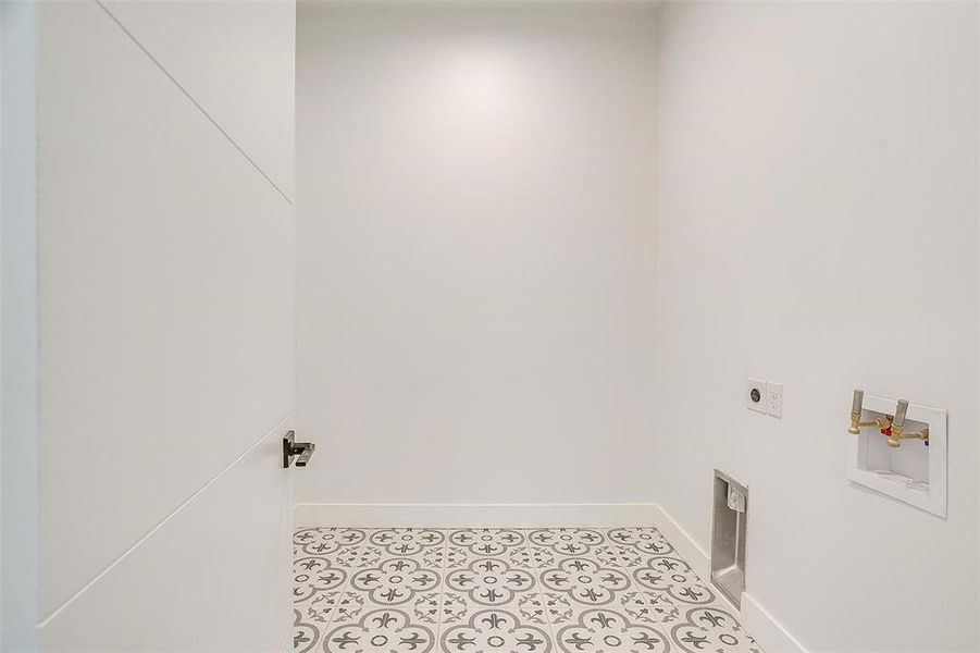 Laundry area featuring laundry area, hookup for an electric dryer, baseboards, and light tile patterned flooring