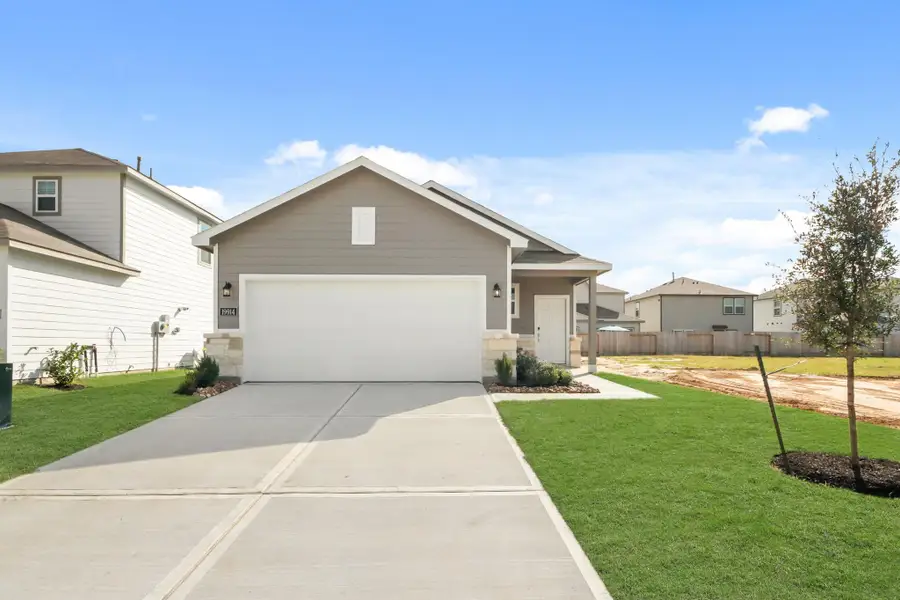 Front exterior of a new home in Northpark South, Porter, TX, highlighting curb appeal (Image 16). Front exterior of a new home in Northpark South, Porter, TX, highlighting curb appeal (Image 16).