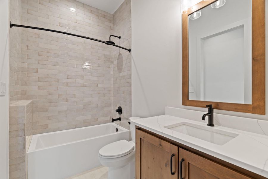 Bathroom  with vanity and  shower combination connected to bedroom 3 upstairs.