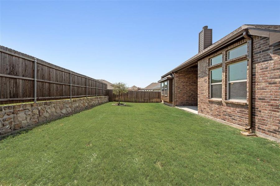 Fenced backyard featuring a patio Fenced backyard featuring a patio