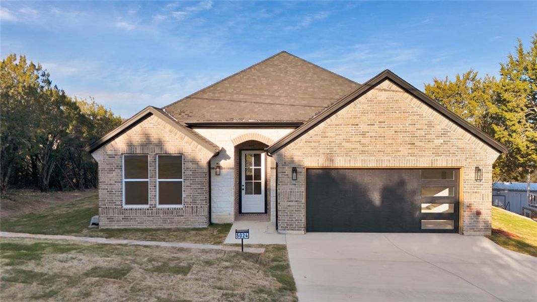 View of front of property featuring a garage.