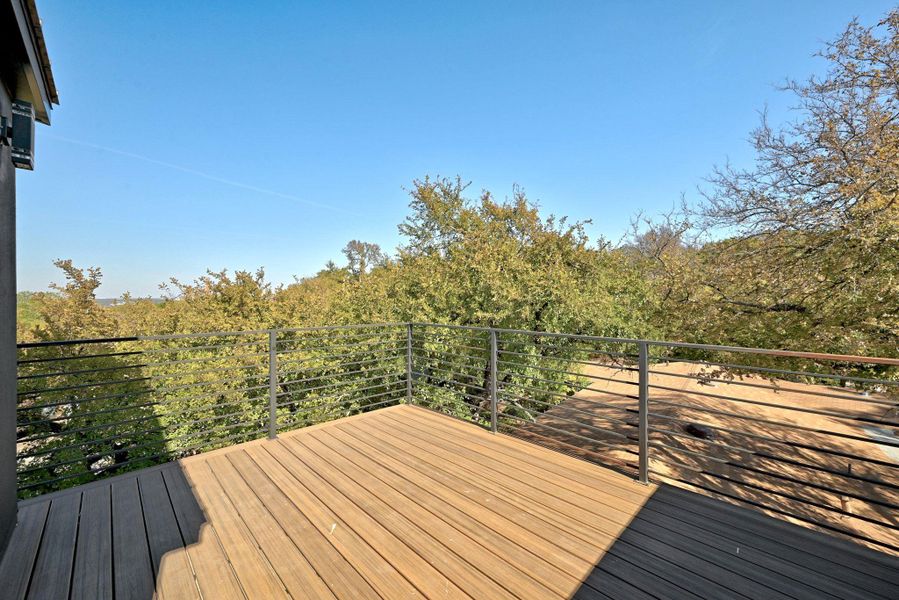 Private deck off of workout room/office with an outdoor living space plus tree top views