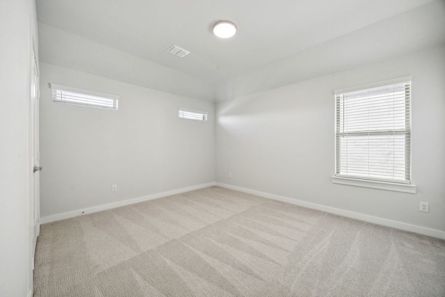 Bedroom in the Wimbledon home plan by Trophy Signature Homes – REPRESENTATIVE PHOTO