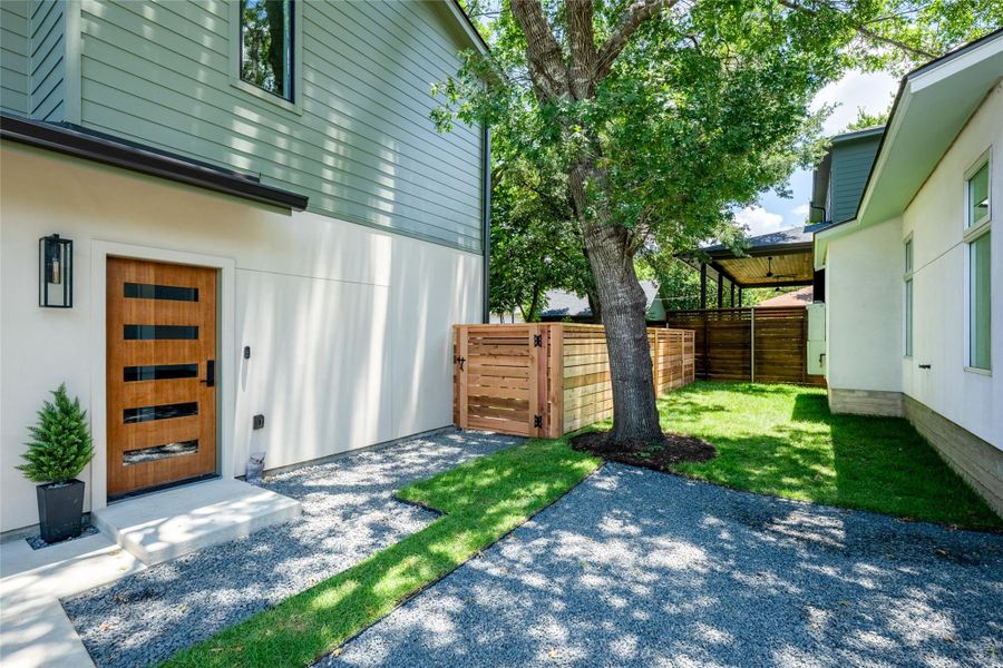 Modern architecture with wood siding and stone accents creates an inviting side entrance. Modern architecture with wood siding and stone accents creates an inviting side entrance.