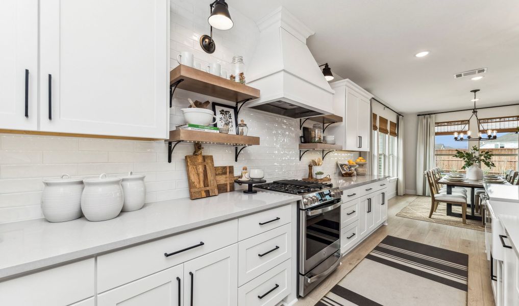 Kitchen with floating cabinets and pendant lights