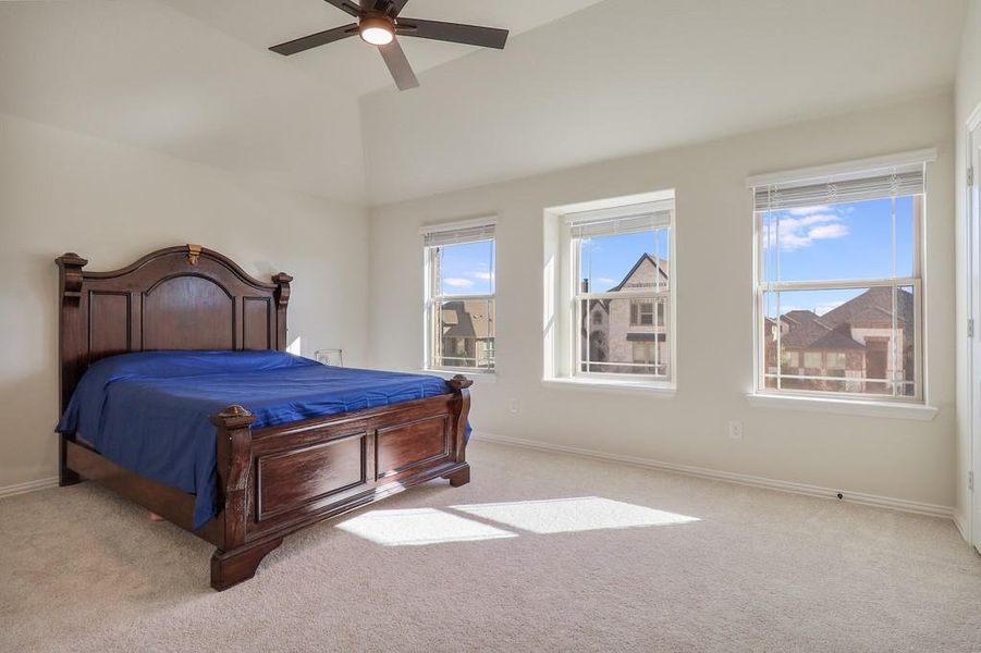 Bedroom with carpet and a ceiling fan Bedroom with carpet and a ceiling fan