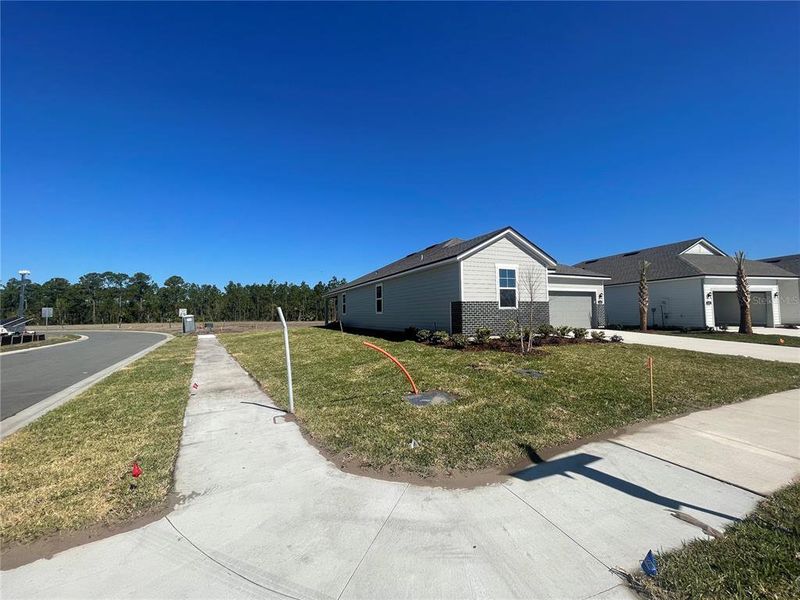 Front exterior of a new home in Magnolia Series at Seminole Palms, Palm Coast, FL, highlighting curb appeal (Image 22). Front exterior of a new home in Magnolia Series at Seminole Palms, Palm Coast, FL, highlighting curb appeal (Image 22).