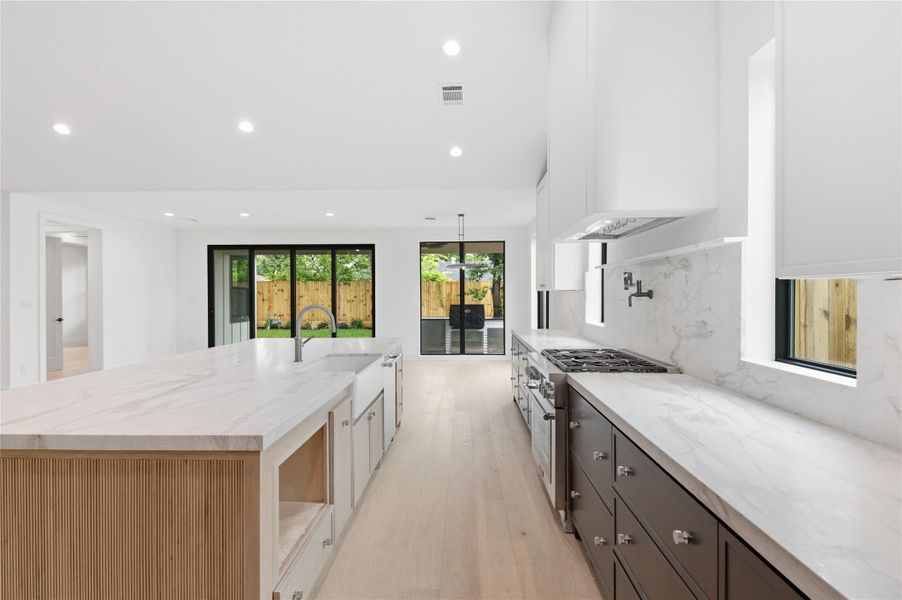 This modern kitchen is anchored by a huge statement island, offering the perfect setting for hosting family and friends.