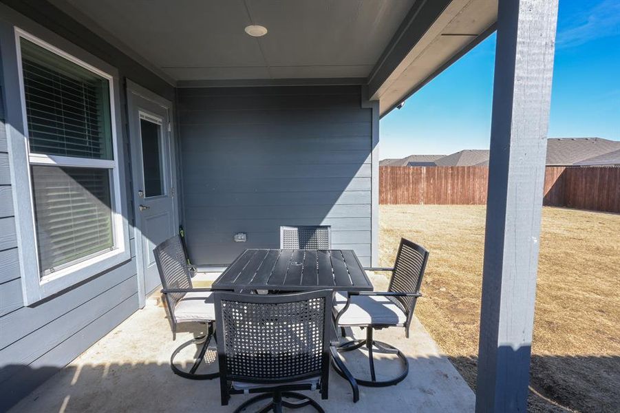 View of patio featuring outdoor dining space and a fenced backyard
