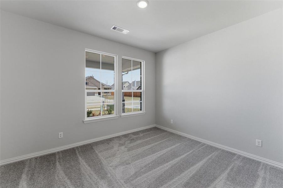 Empty room with baseboards and light carpet