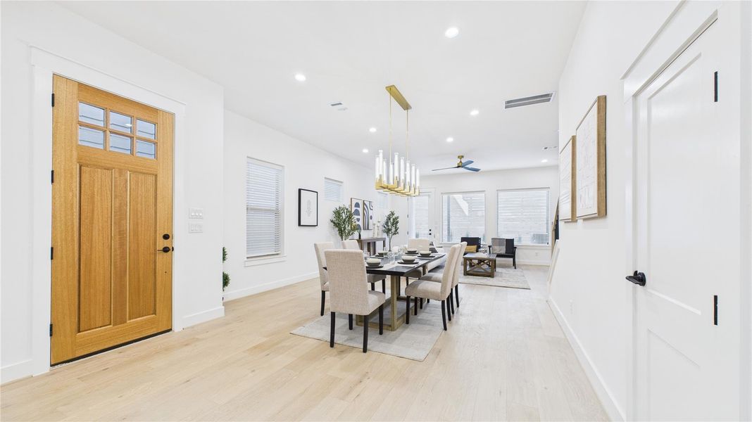 View of the entry and the dining. There is extra storage under the stairs.