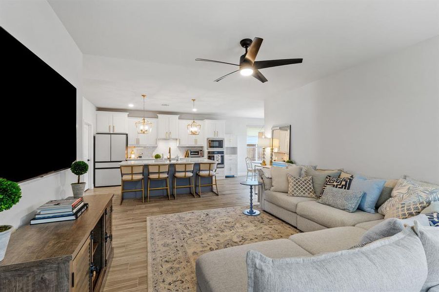 The spacious great room offers ample space to comfortably host gatherings and celebrate with friends and family. Its open layout encourages easy mingling, making every party a memorable event.