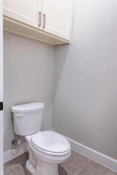 Bathroom featuring tile patterned flooring and baseboards Bathroom featuring tile patterned flooring and baseboards