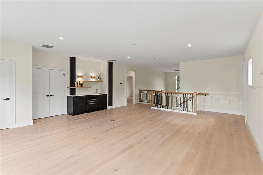 Upstairs loft with wet bar with beverage fridge and sliding glass doors leading to the balcony overlooking the beautiful backyard Upstairs loft with wet bar with beverage fridge and sliding glass doors leading to the balcony overlooking the beautiful backyard