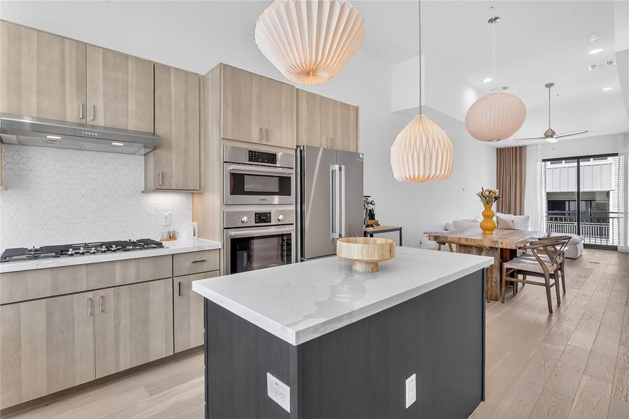 Culinary excellence awaits in this open-concept kitchen featuring an island and premium appliances.