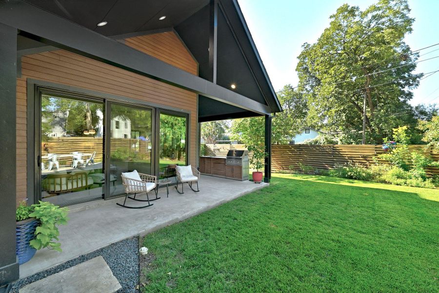 Side of home showing off covered patio, lawn and landscaping Side of home showing off covered patio, lawn and landscaping