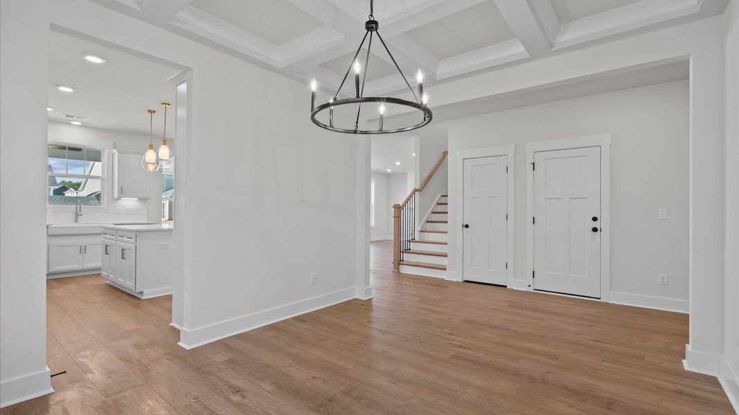 First-class dining area featuring a coffered ceiling and thoughtful architectural detail First-class dining area featuring a coffered ceiling and thoughtful architectural detail