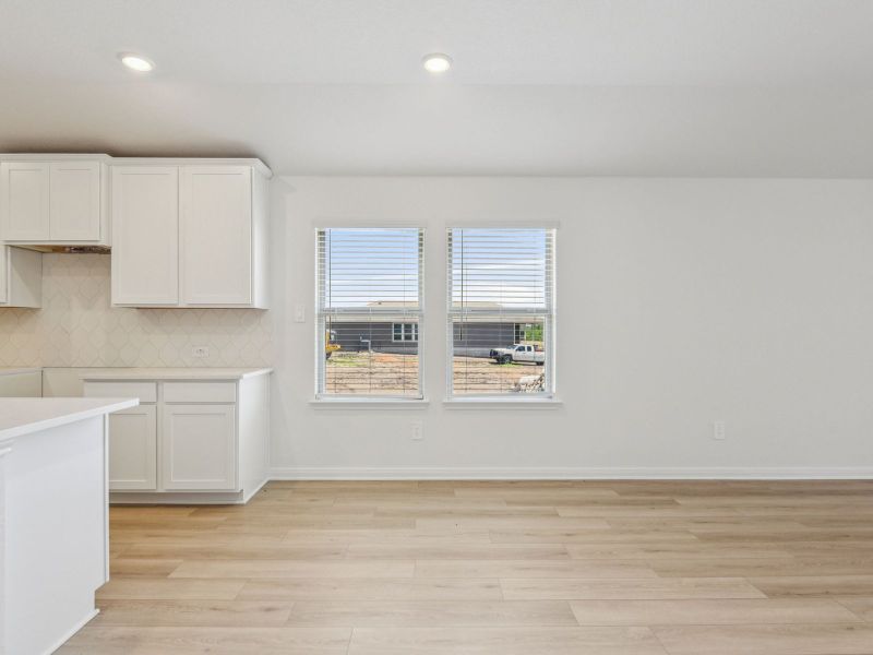 Kitchen and dining room in the Allen floorplan at a Meritage Homes community. Kitchen and dining room in the Allen floorplan at a Meritage Homes community.