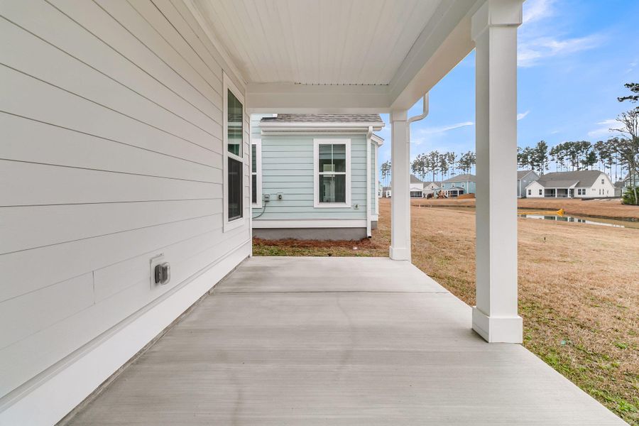 Exterior details and patio area of a home in Tidewater at Lakes of Cane Bay, Summerville (Image 26).