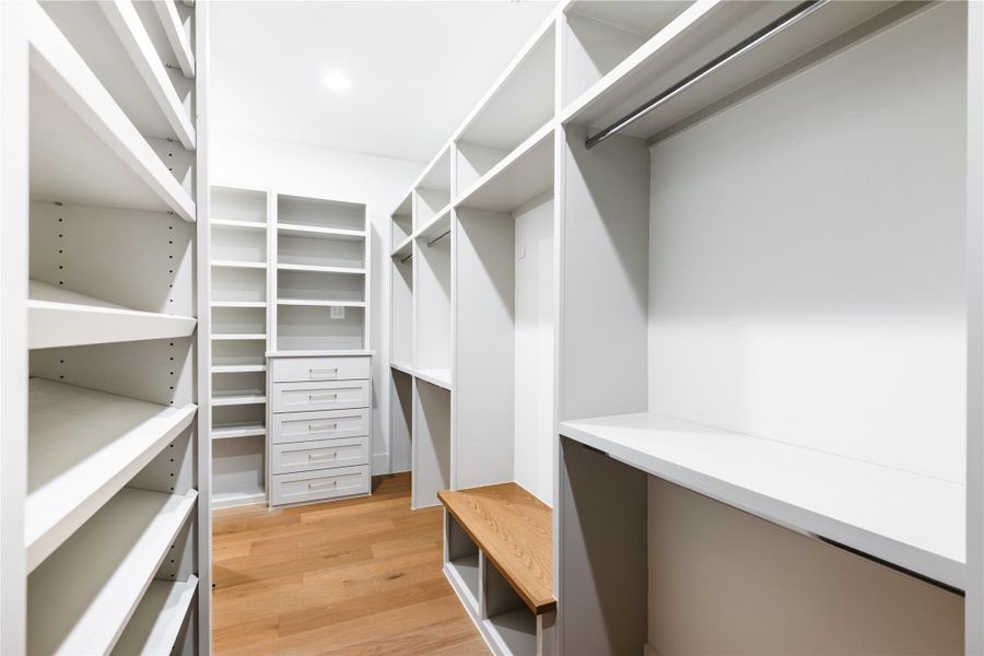 Primary closet with custom cabinetry