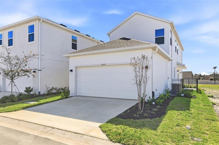 Front exterior of a new home in Vivir, Valrico, FL, highlighting curb appeal (Image 26).