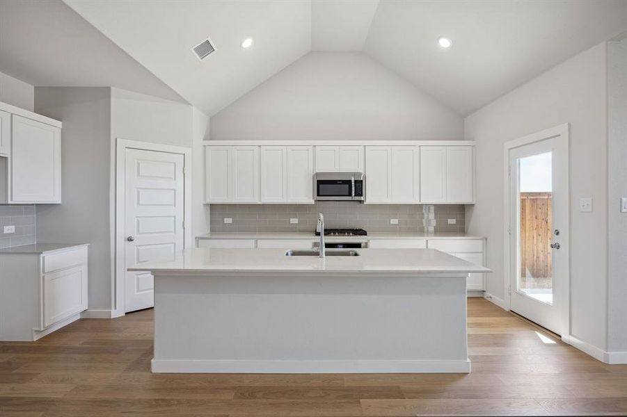 Kitchen in the Wimbledon home plan by Trophy Signature Homes – REPRESENTATIVE PHOTO
