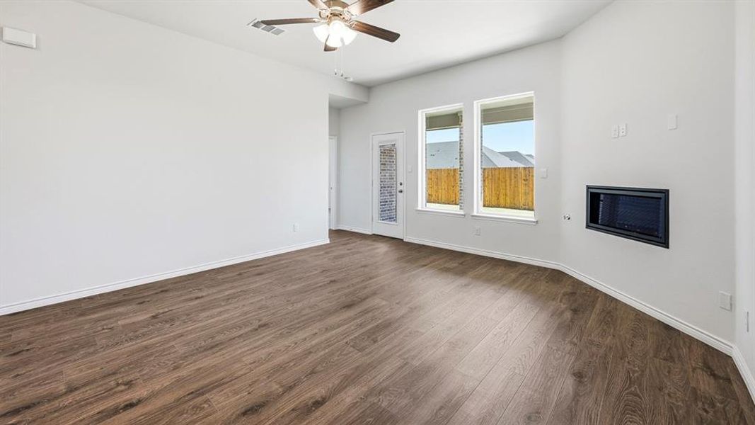 Spare room with dark wood-type flooring and a ceiling fan