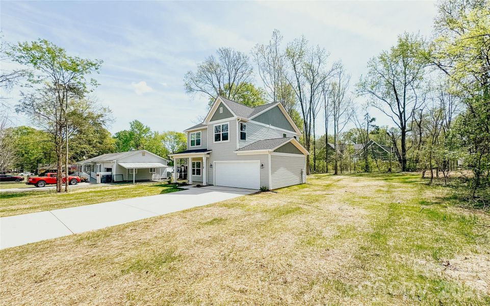 Front exterior of a new home in , Harrisburg, NC, highlighting curb appeal (Image 19).