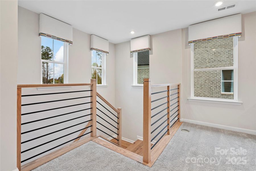 Modern open rail opens up the loft space to light and flow.