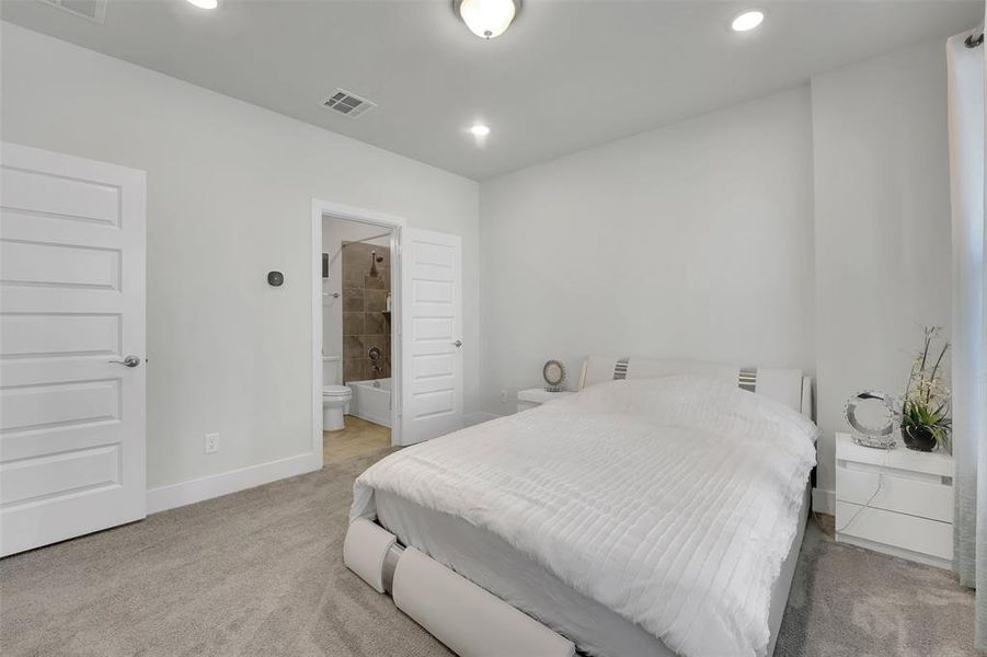 Carpeted bedroom with ensuite bath