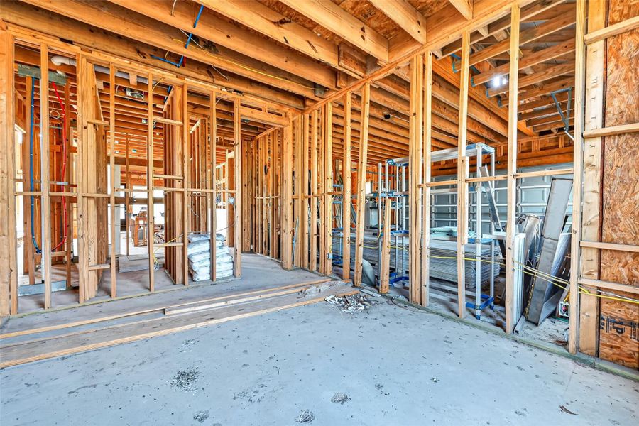 Open unfinished space showcasing framing and build progress.