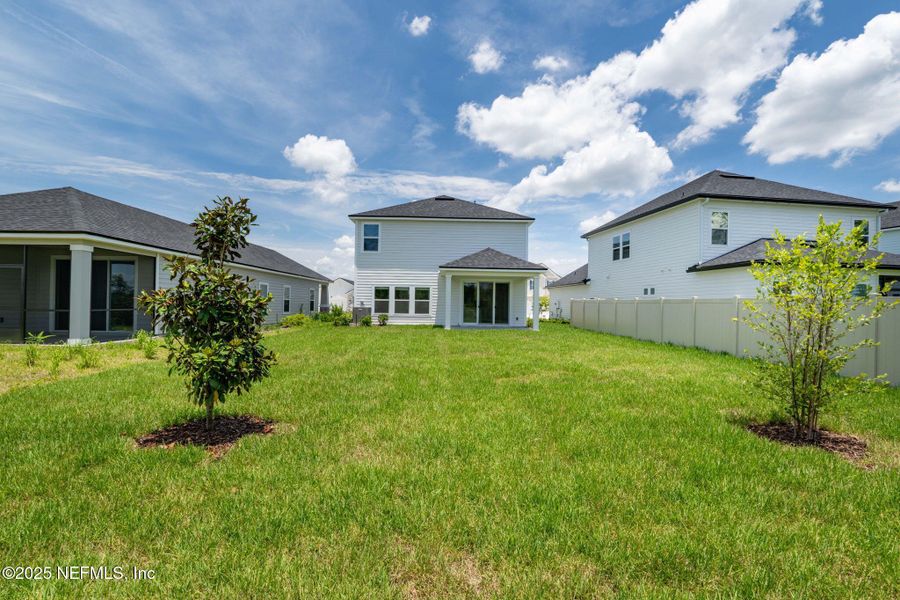 Front exterior of a new home in Beacon Lake, St. Augustine, FL, highlighting curb appeal (Image 18).