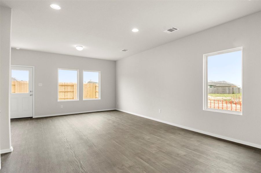 Spare room with recessed lighting, plenty of natural light, and light wood-style floors