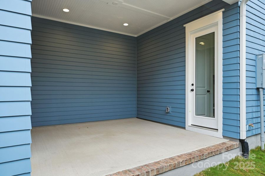 A convenient side porch connects the house to the garage, providing privacy and protection from the weather elements. A convenient side porch connects the house to the garage, providing privacy and protection from the weather elements.